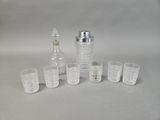 bottles and glasses are lined up on a white surface