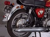 a red motorcycle that is parked in a garage