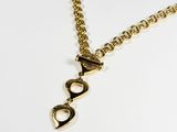 a close up of a gold necklace on a white surface