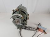 a close up of a small motor on a white surface