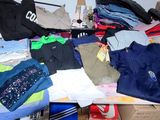 a pile of clothing sitting on a table in a room