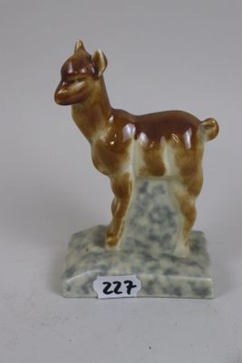 a figurine of a llama standing on a rock