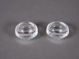 pair of clear glass ashtrays sitting on top of a table