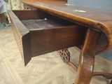 a wooden desk with a drawer underneath it