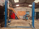 a picture of a garage with a car being worked on