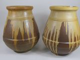 two brown vases sitting next to each other on a table