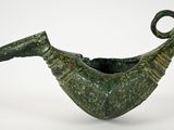 an image of a green vase with a curved handle on a white surface