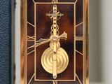 a clock that is sitting on a table next to a book