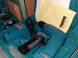 a blue tool box with tools in it on a table