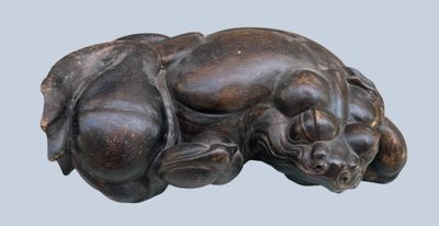 an image of a statue of a dog laying down on its back