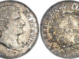 a silver coin with a crown on the front and a crown on the back