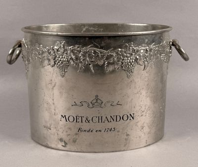 a silver ice bucket with grapes on it