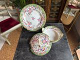 two plates and a bowl on a table in a room