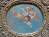 une photo d'un tableau représentant deux chérensils, dans un cadre doré