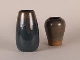two vases sitting next to each other on a table