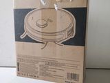 an image of a cardboard box with a vacuum cleaner on top of it