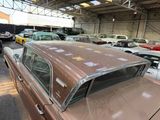 many old cars parked in a garage with a lot of them