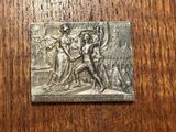 an image of a metal plaque on a wooden table