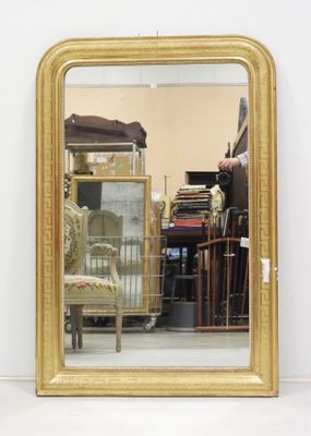 a mirror that is sitting on the floor in front of a chair