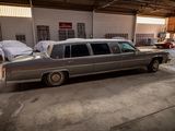 a car that is parked in a garage next to other cars