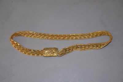 a gold chain belt with a clasp on it
