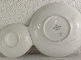 a white bowl and a white plate sitting on a table