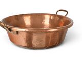 an image of a copper pan with handles on a white background
