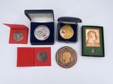 a box of medals and other items on a white surface