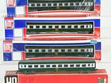 three boxed train cars sitting on top of each other on a white surface