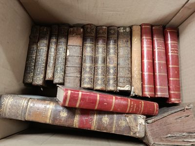 a box full of old books sitting on a table