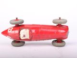 a red toy car with wheels on a white surface