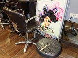 a picture of a salon with a chair and a sign