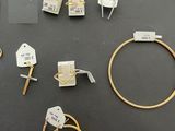 several gold rings, bracelets, and other jewelry are displayed on a table