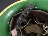 a close up of a green helmet with a leather strap