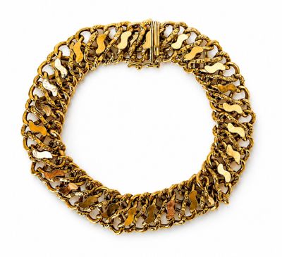 a close up of a gold chain bracelet on a white background