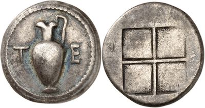 a close up of a silver coin with a vase on it