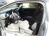 the interior of a car with the door open showing the steering wheel and dashboard