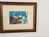 a picture of a painting hanging on the wall above a bed