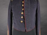 a blue jacket with red trims and buttons on a mannequin