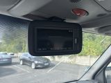a rear view mirror of a car in a parking lot