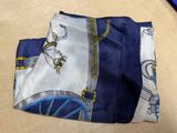 a blue and white scarf with a picture of a man on a bike
