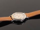 an image of a watch with a brown leather strap on a black surface