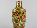a vase that is sitting on a white surface