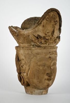 une image représentant un vase en forme de tête de pierre sur lequel est représenté un visage