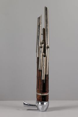 a metal and wood object with a spoon in it
