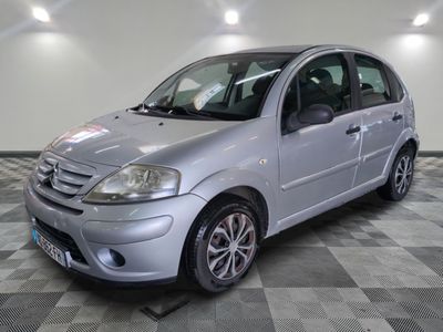 a picture of a small silver car parked in a garage