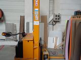 a fork lift in a garage with a lot of wood