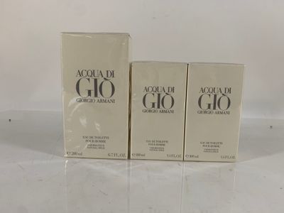 two boxes of acqua di gio cologne sitting on a table
