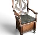 a wooden chair with a black seat and a bird on the back