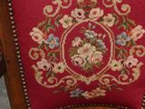 a red chair with a floral design on the back